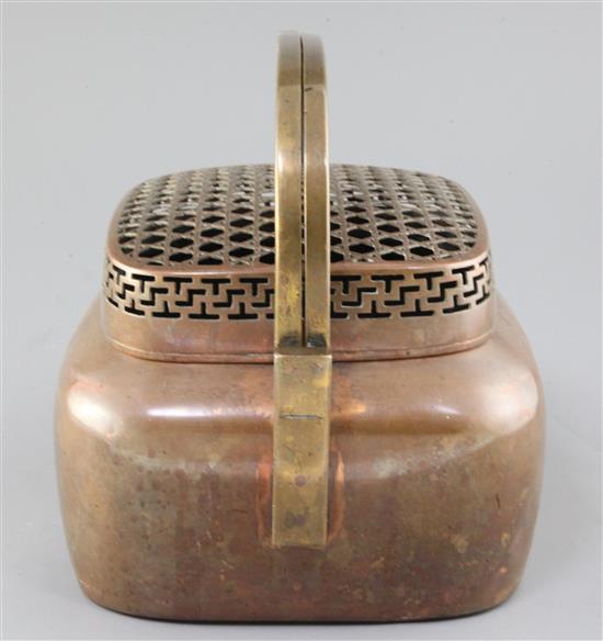 A large Chinese copper alloy hand warmer, 17th / 18th century, width 27cm